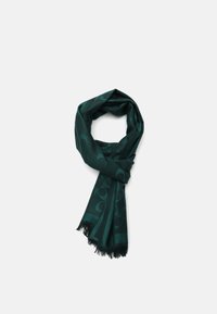 Écharpe vert foncé avec un motif subtil, bords frangés, texture douce et forme longue et rectangulaire adaptée à diverses options de style.
