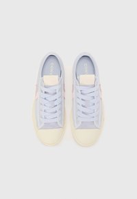 Light blue sneakers with a textured canvas and suede upper, featuring pink accents, flat laces, and a cream-colored rubber sole.