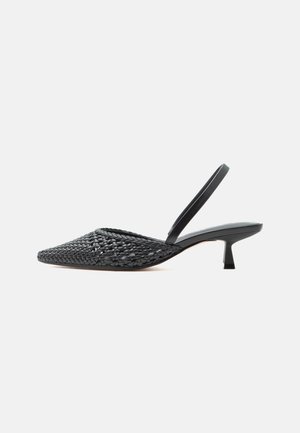 Black woven pointed-toe slingback shoe with a low kitten heel on a plain light background.