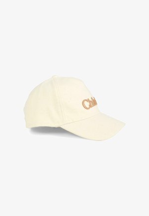 Cappello color crema con una texture morbida, visiera curvata e logo "Child" ricamato in marrone sulla parte anteriore. Design classico e vestibilità regolabile.