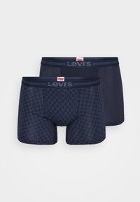 Navy blue boxer briefs featuring a pattern on one pair and a solid design on the other, with a branded elastic waistband.