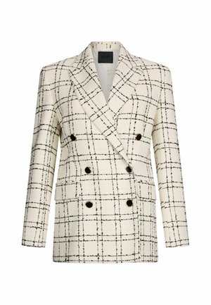Blazer doppiopetto bianco e nero a scacchi, con bottoni dorati, spalle strutturate e un tessuto testurizzato con un motivo a griglia.