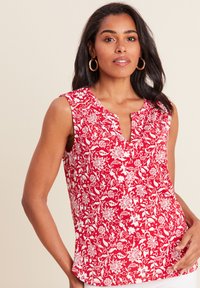 Top senza maniche floreale rosso con scollatura a V, dettagli con bottoni e un motivo di fiori e viti bianchi. Tessuto morbido con una vestibilità comoda.