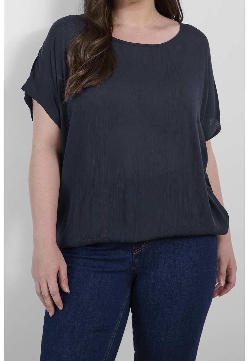 Loose-fitting, navy top in lightweight fabric, featuring a round neckline and short sleeves. Smooth texture with subtle vertical lines.