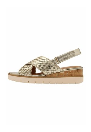Bronze woven sandal with cross-straps, cork midsole, and a light rubber outsole. Features a slingback strap for support.