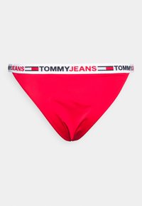 Parte de baixo de biquíni vermelha, feita de tecido suave, com uma cintura branca apresentando "TOMMY JEANS" e um design de logotipo em block color.