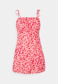 Pink dress with a floral heart pattern, adjustable spaghetti straps, gathered bodice, and a flowing shape. Made of lightweight fabric.