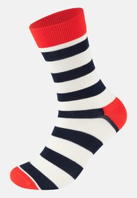 Chaussettes rayées en blanc, marine et orange. Elles présentent un revers côtelé, une longueur mi-mollet et des accents de talon et d'orteil orange uni.