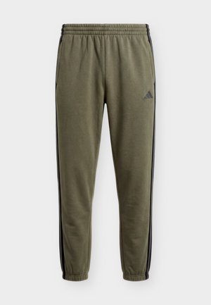 adidas Sportswear, ESSENTIALS 3 STRIPES TAPERED CUFFED PANTS - Trainingsbroek - olive four/black
