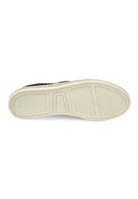 Schoenenzool met een getextureerd, geribbeld ontwerp in Off-white rubber, met een zwarte stoffen bovenkant en een natuurlijk getinte accent rond de rand.