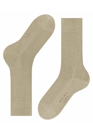 Beige cotton socks with a smooth texture, featuring a reinforced heel and toe, and subtle branding on the sole.