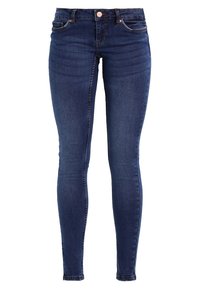 Smaljeans i mörkblå denim, med framfickor, baktfickor och dragkedja. Tyget har en mjuk textur med lätt blekning.