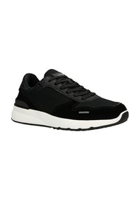 Schwarze Sneaker, die eine Mischung aus Materialien wie Wildleder und Stoff präsentieren, mit einer weißen Zwischensohle und einer strukturierten schwarzen Außensohle. Klassisches Schnürdesign.