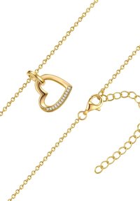 Zlatna ogrlica s privjeskom u obliku srca, ukrašena prozirnim kristalima, s kamenčićem za zakretanje i delikatnom lancem s poveznicom.