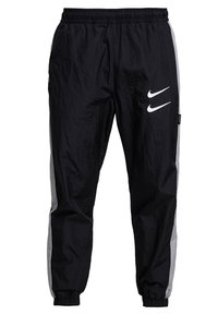 Pantalons coupe-vent noirs avec des rayures latérales grises, taille élastique et poignets élastiques. Présente un logo blanc sur la cuisse gauche.