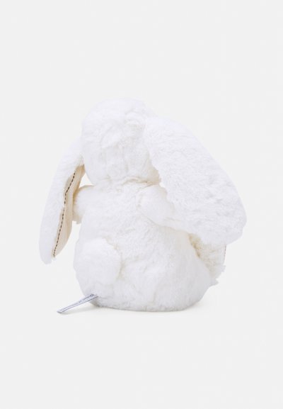 Jouet en peluche blanc en forme de lapin avec de longues oreilles et un corps rond, présentant une texture douce et duveteuse ainsi qu'une petite queue arrondie.