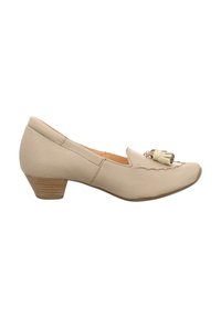 Beige Damen-Schuh mit niedrigem Blockabsatz, glatter Lederoberfläche, runder Zehenform und einem dekorativen Quastenakzent auf dem Blatt.
