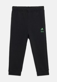 Black sweatpants featuring a green Adidas logo and "Disney" branding, designed with an elastic waistband and cuffs.