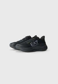 Black athletic shoes with a textured upper, logo on the side, and a cushioned sole. Features laces and padded collar for comfort.
