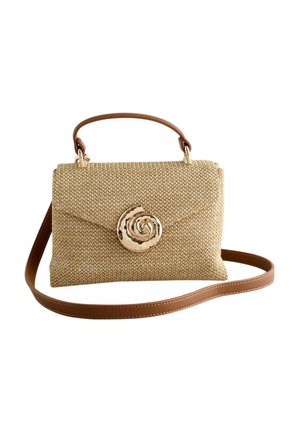 Woven beige handbag with brown leather handle and strap, featuring a large gold spiral shell-shaped clasp on the front flap.