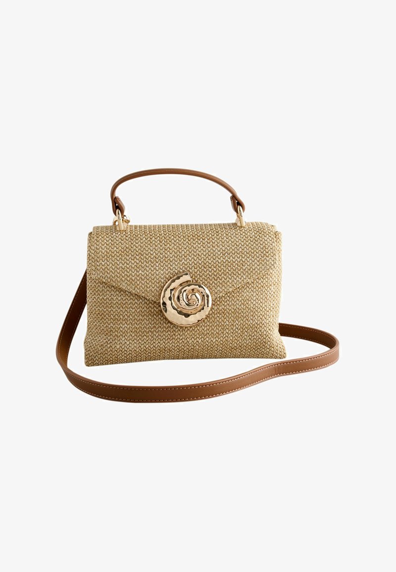 Woven beige handbag with brown leather handle and strap, featuring a large gold spiral shell-shaped clasp on the front flap.