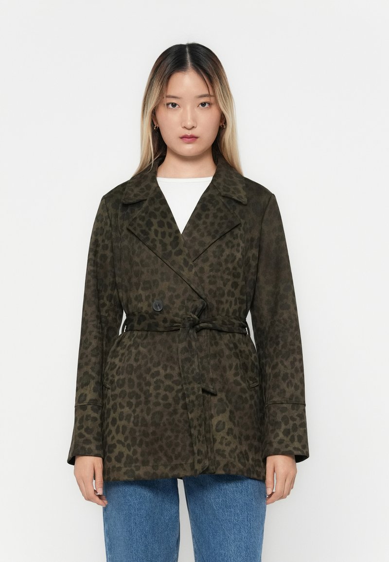 Leopard print coat in dark olive green. Features a double-breasted design, wide lapels, tie waist, and soft texture. Paired with denim.