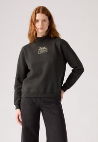 Sötétzöld pulóver magas nyakkal és hosszú ujjakkal. Arany "Levi's" logó található a mellkasán. Strukturált anyag ribbelt mandzsettákkal.