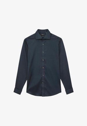 Tumesinist pikka varrukaga särk, mis on valmistatud siledast kangast, klassikalise krae, nööbitava eesosa ja nööbitavate mansettidega. Muster ega aksessuaare puuduvad.