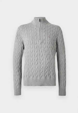 Heled hõbedane nööriga kampsun, millel on veerand tõmblukk ja väike brändi logo rinnal, soonikkoes mansetid ja äär.