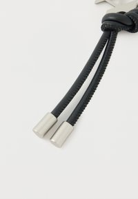 Black leather cord with two silver metal ends, featuring braided texture and a smooth finish for added durability.
