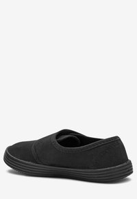 Schwarzer Slipper aus Canvas mit runder Zehenpartie, elastischen seitlichen Akzenten und einer strukturierten Gummisohle. Einfaches Design mit minimaler Naht.