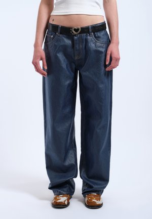 Wide-leg dark blue denim trousers with a shiny finish, featuring a black belt with a heart-shaped buckle and visible stitching details.