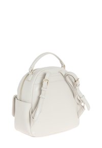 Borsa in pelle bianca con forma arrotondata, manico superiore, tracolla regolabile, accessori in oro e chiusura con zip. Dettaglio della tasca laterale.
