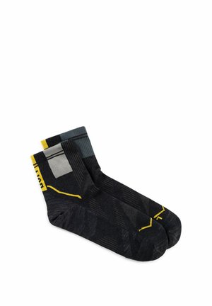 Pair of black ankle socks with gray and yellow geometric patterns, laid flat on a white background.