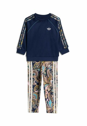 Marineblauw top met lange mouwen met patroonstrepen op de schouders en multicolor paisley print broek met witte zijstrepen.