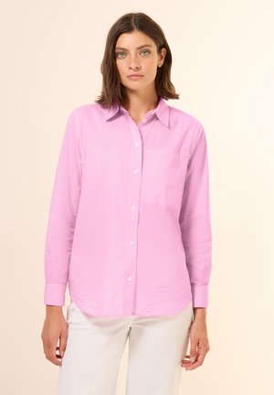 Light pink long-sleeve button-up shirt with a classic collar and a front pocket detail, made from a smooth, lightweight fabric.