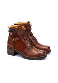 Brown ankle boots made of leather and suede, featuring a lace-up design, padded collar, and a textured block heel.