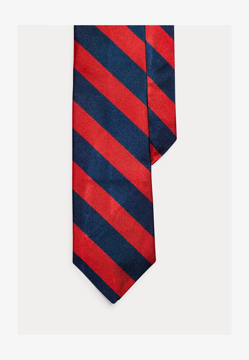 Γραβάτα με κόκκινες και ναυτικές ρίγες από υφαντό ύφασμα. Διαθέτει διαγώνιες ρίγες, ομαλή υφή και σχεδιασμό με μυτερή άκρη.