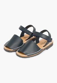 Granatowe skórzane sandały z otwartym noskiem, regulowanym paskiem i beżową skórzaną wkładką. Posiadają białe przeszycia i trwałą czarną gumową podeszwę.