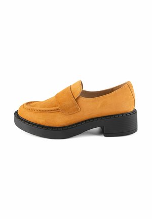 Loafers in soft mustard suede with a black rubber block heel. Features rounded toe and single strap across the upper for secure fit.