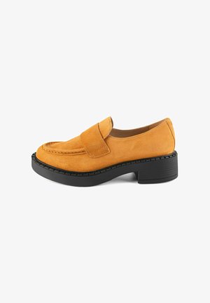 Loafers in soft mustard suede with a black rubber block heel. Features rounded toe and single strap across the upper for secure fit.