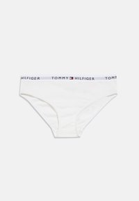 Valged puuvillased püksikud, mille vööl on logo "TOMMY HILFIGER" ja värvitud embleem. Sile tekstuur ja klassikaline püksiku disain.