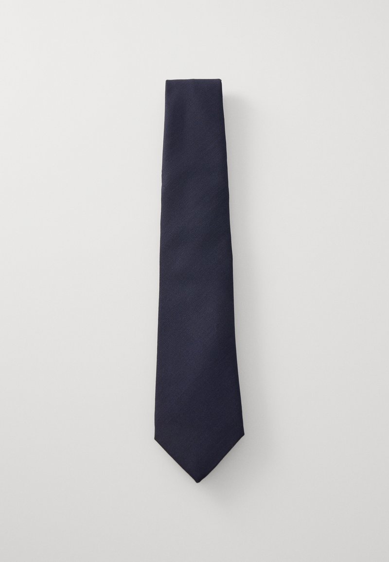 Navy blue tie made of textured fabric, featuring a narrow design with a pointed tip and no visible patterns or accents.