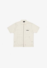 Short-sleeve cream jacket made of heavy fabric with zip closure, two front pockets, and embroidered "HACKER" logo in black.