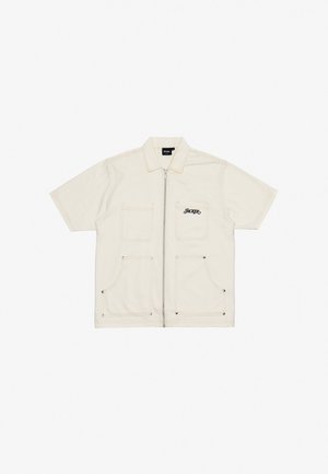 Short-sleeve cream jacket made of heavy fabric with zip closure, two front pockets, and embroidered "HACKER" logo in black.