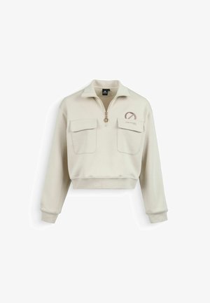 Beige cropped sweatshirt with front zipper, two flap pockets, and a round logo with text on the left chest.