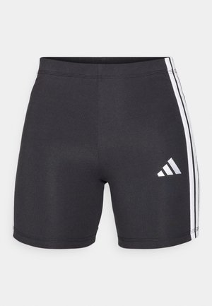 Calções atléticos pretos feitos de tecido elástico, com riscas laterais brancas e um logótipo da Adidas na parte inferior da perna direita. Textura suave.