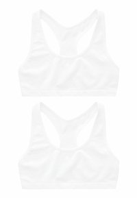 Białe sportowe biustonosze z konstrukcją w stylu racerback, wykonane z gładkiego materiału, z wyprofilowanymi szwami i bezszwowym paskiem na dole.