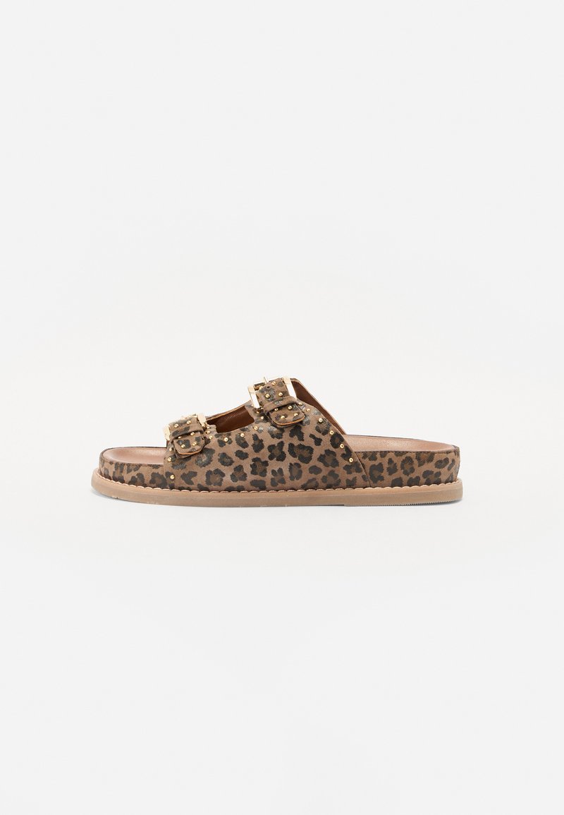 Leopard print slide sandals with two gold-accented buckles. Made of soft material with a flat sole. Textured upper featuring small studs.