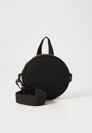 Black round bag made of fabric with a zipper closure, featuring a prominent embossed logo, a top handle, and a detachable strap.